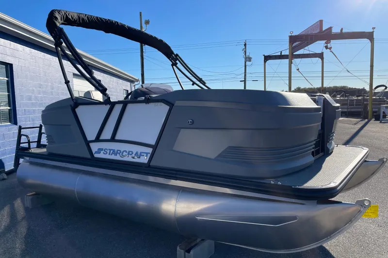 Slide: The Image of 2026 Starcraft GX 16 R pontoon boat displayed outdoors on a sunny day. - 13