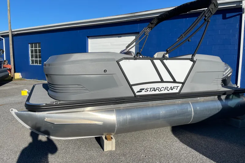 Slide: The Image of 2026 Starcraft GX 16 R pontoon boat displayed outdoors on a sunny day. - 8