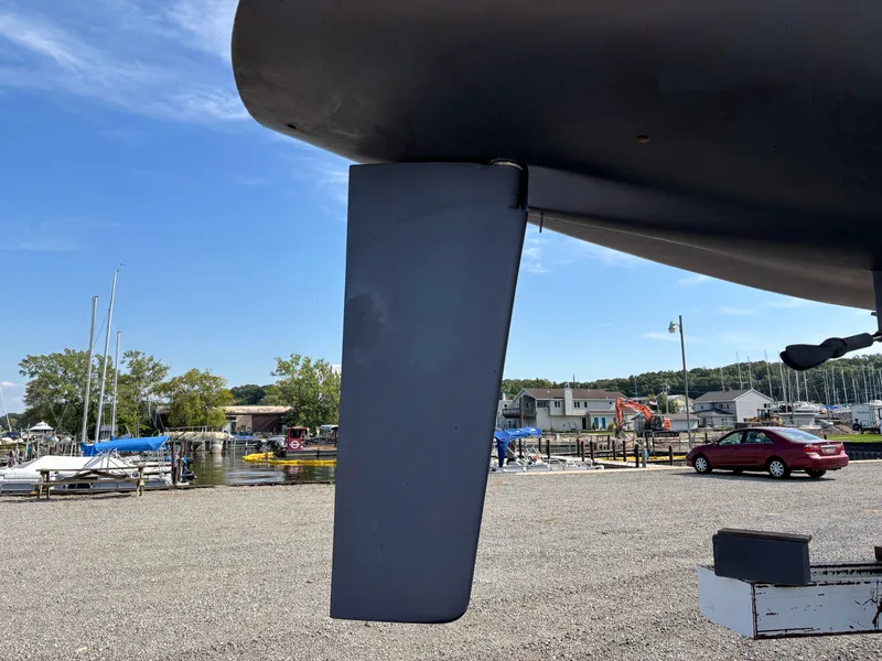 Slide: The Image of Rudder of 1987 Goman Express 35 sailboat in a marina setting. - 10