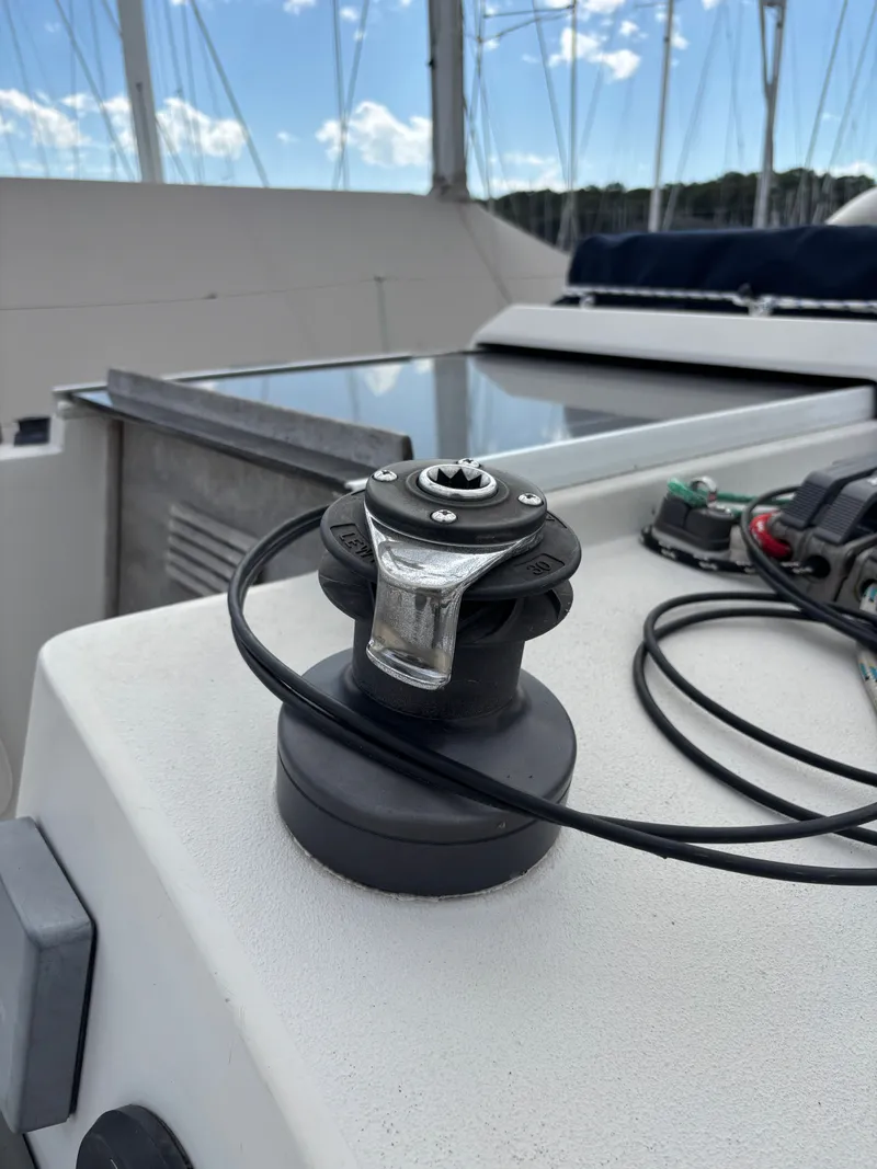 Slide: The Image of Winch on 1987 Goman Express 35 sailboat deck under blue sky. - 16