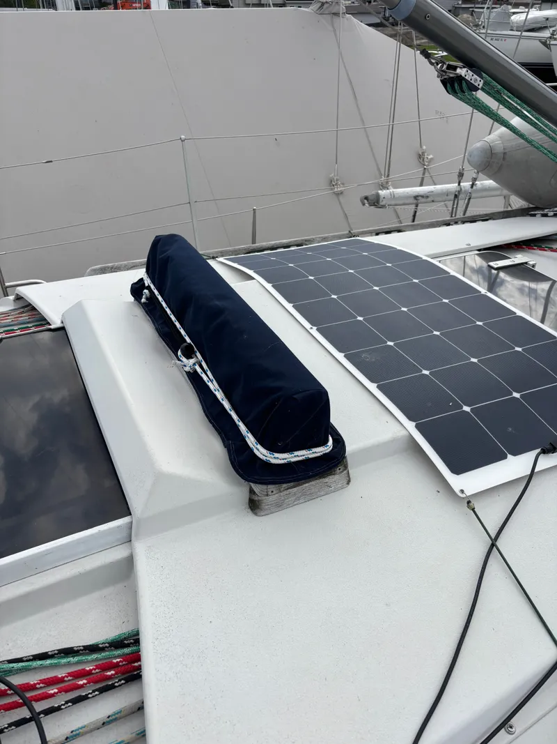 Slide: The Image of 1987 Goman Express 35 sailboat deck with solar panel and covered equipment. - 17