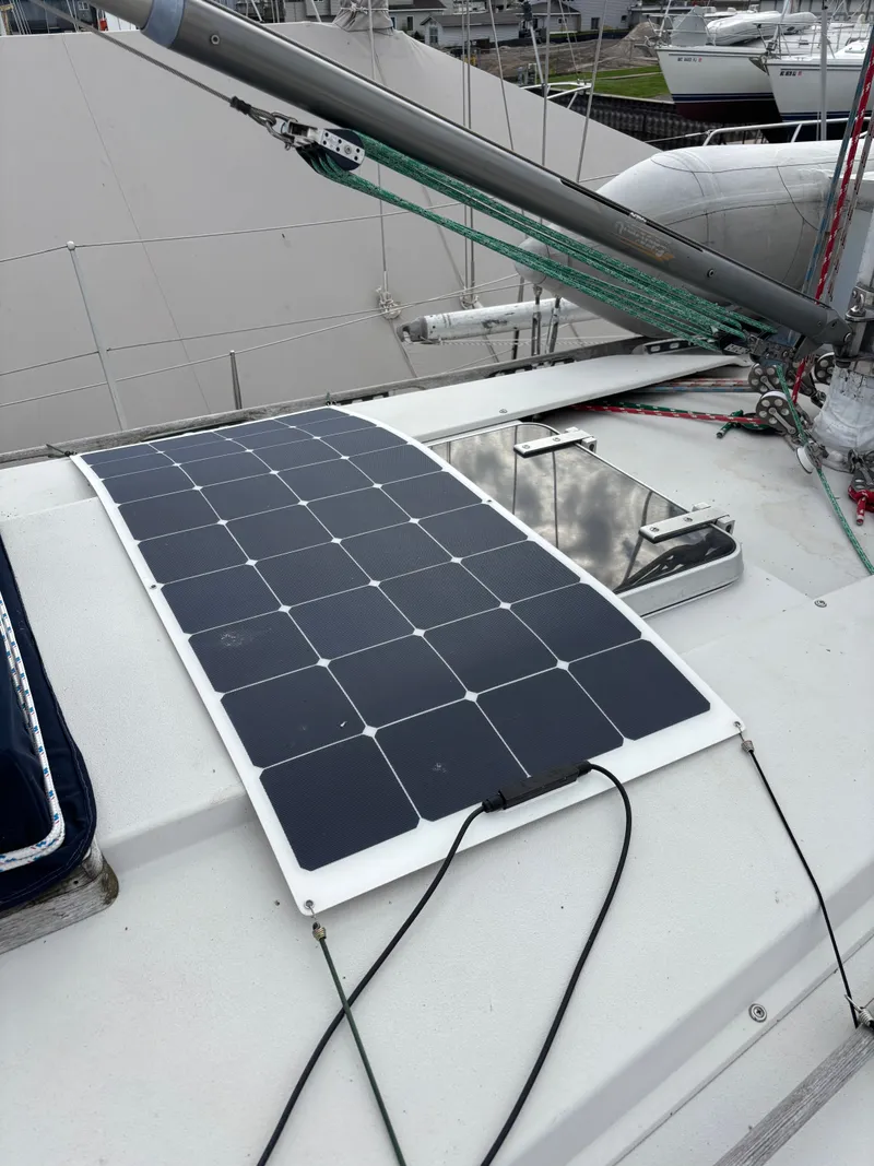 Slide: The Image of Solar panel on 1987 Goman Express 35 sailboat deck, docked with other boats. - 18