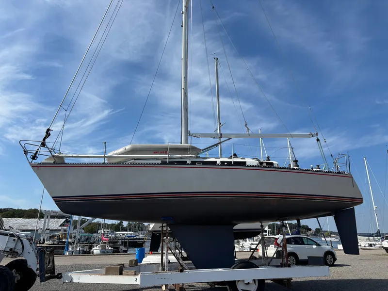 Slide: The Image of Sailboat Goman Express 35, 1987 model, on dry dock under a clear blue sky. - 2