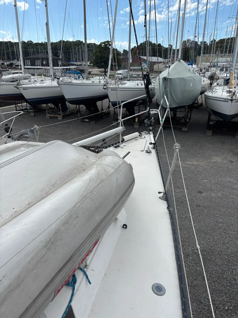 Slide: The Image of 1987 Goman Express 35 sailboat on dry dock, surrounded by other boats. - 20