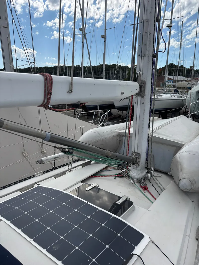 Slide: The Image of 1987 Goman Express 35 sailboat with solar panel and rigging in marina. - 22