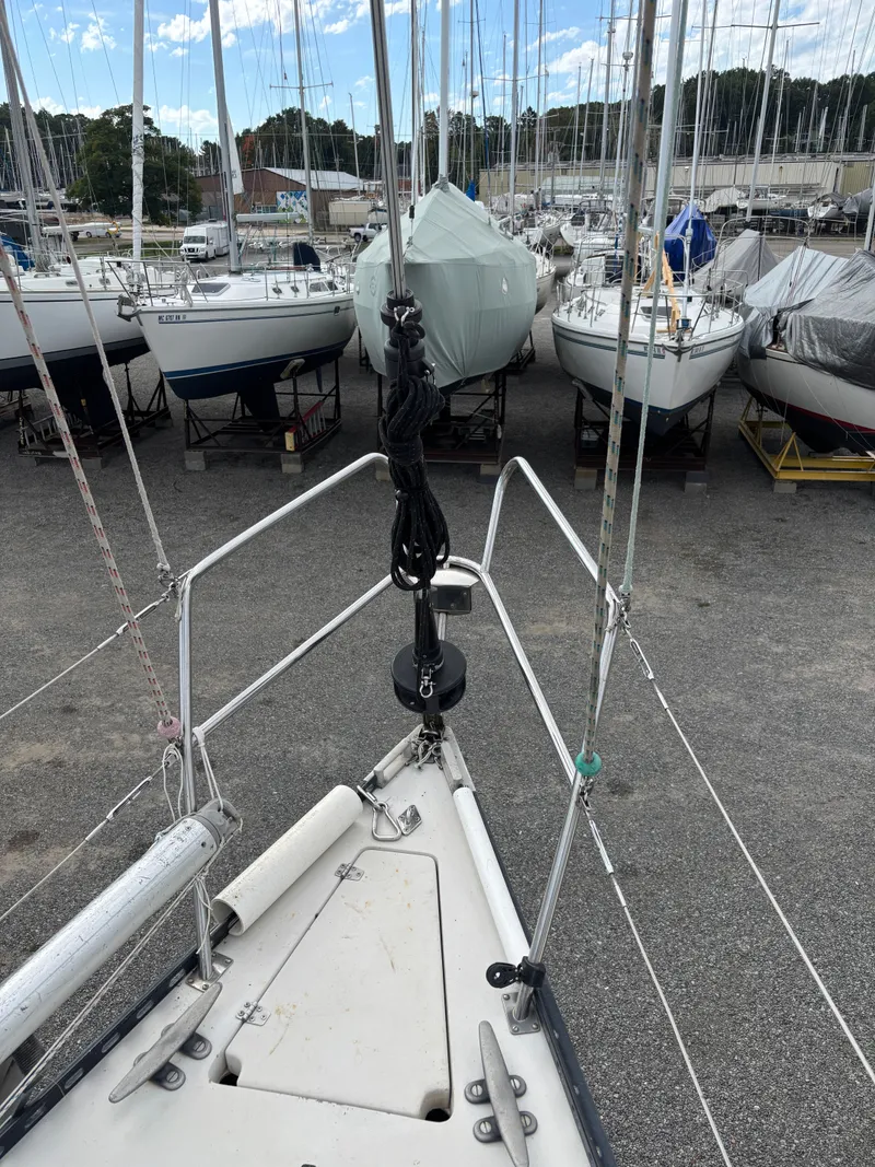 Slide: The Image of Bow view of 1987 Goman Express 35 sailboat in a marina with other boats. - 23