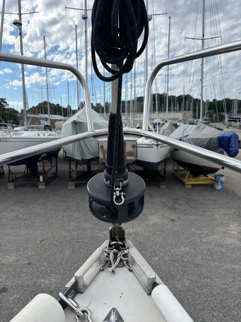 Slide: The Image of Bow of 1987 Goman Express 35 sailboat in marina, surrounded by other boats. - 24