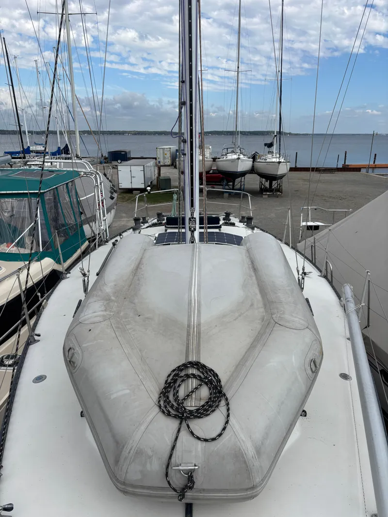 Slide: The Image of 1987 Goman Express 35 sailboat docked, with a view of the marina and distant water. - 27