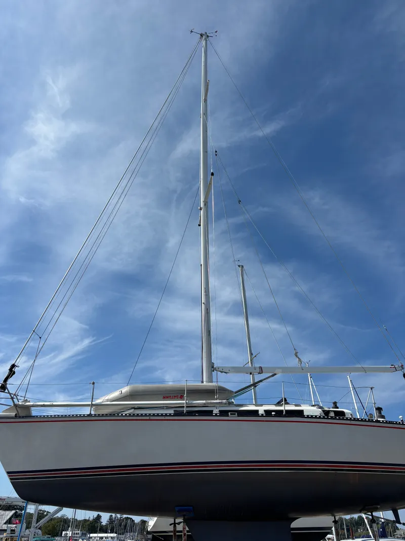 Slide: The Image of 1987 Goman Express 35 sailboat with tall mast against a blue sky. - 3