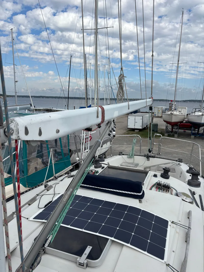 Slide: The Image of Sailboat Goman Express 35 (1987) with solar panel, docked under cloudy sky. - 33