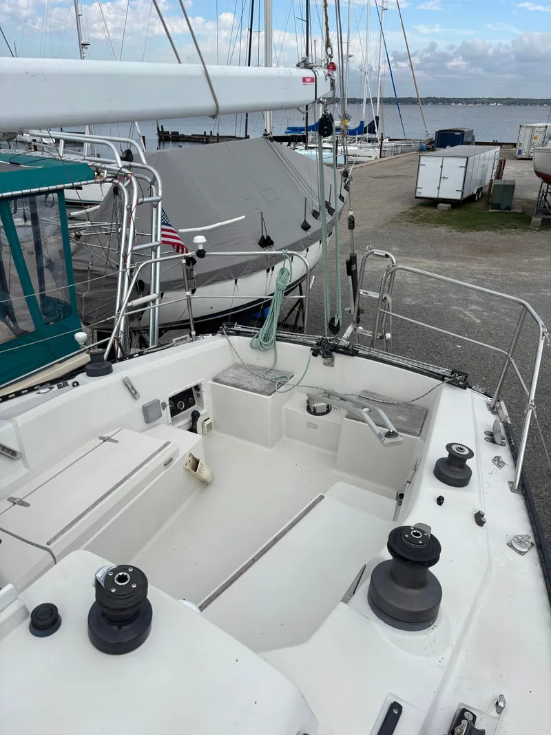 Slide: The Image of 1987 Goman Express 35 sailboat cockpit with winches, docked near other boats. - 38