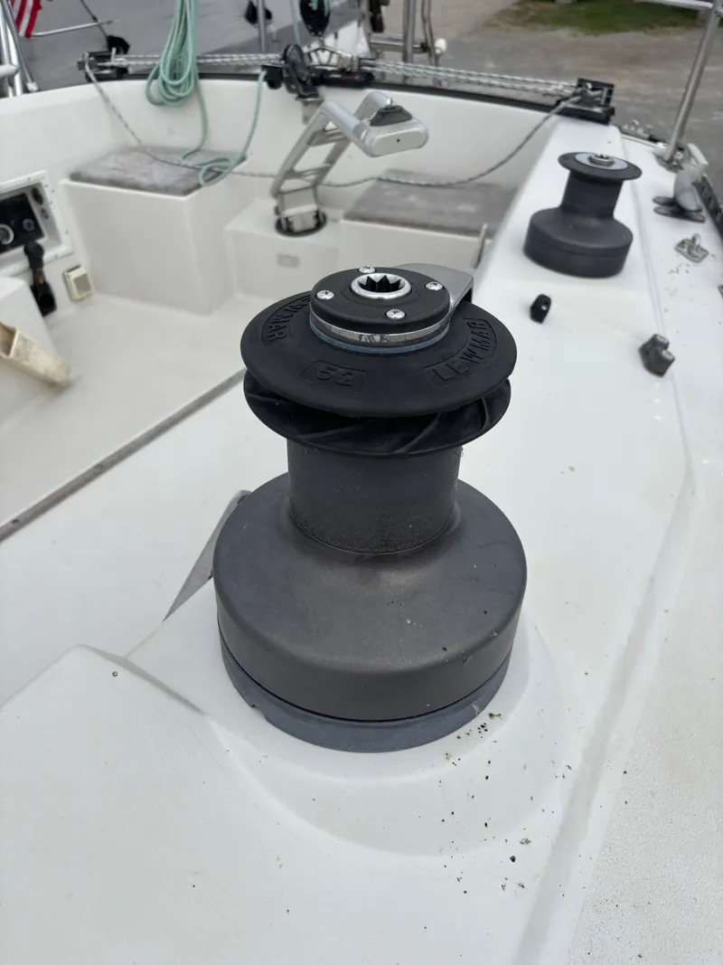 Slide: The Image of Winch on 1987 Goman Express 35 sailboat deck, featuring ropes and cockpit area. - 46