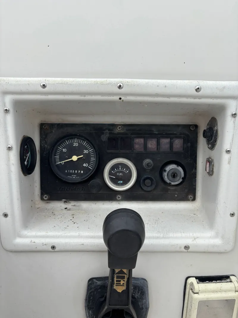 Slide: The Image of Control panel of a 1987 Goman Express 35 boat, featuring gauges and switches. - 47