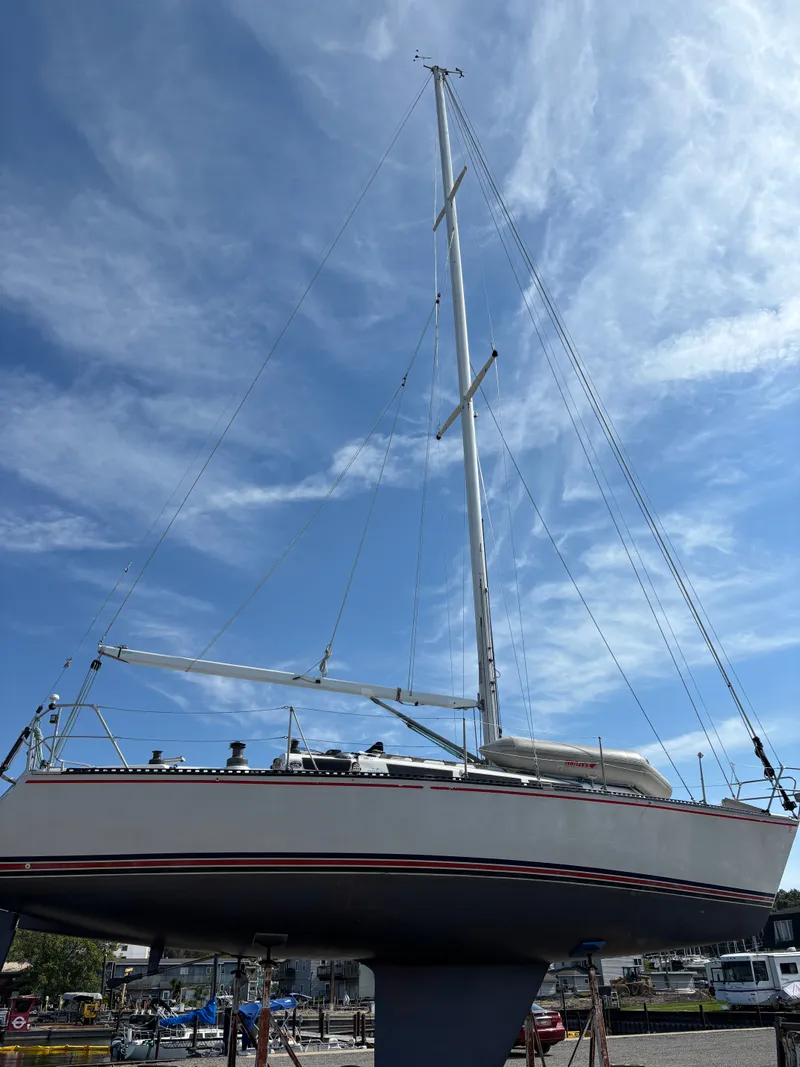 Slide: The Image of 1987 Goman Express 35 sailboat on land under a clear blue sky. - 5