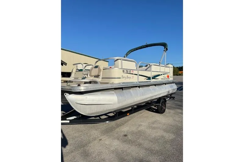The Image of 2010 Sun Tracker Party Barge 20 Classic Series pontoon boat on trailer, sunny day. - 1