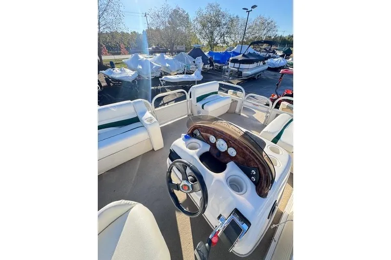 Slide: The Image of 2010 Sun Tracker Party Barge 20 Classic Series interior with steering console and seating. - 12