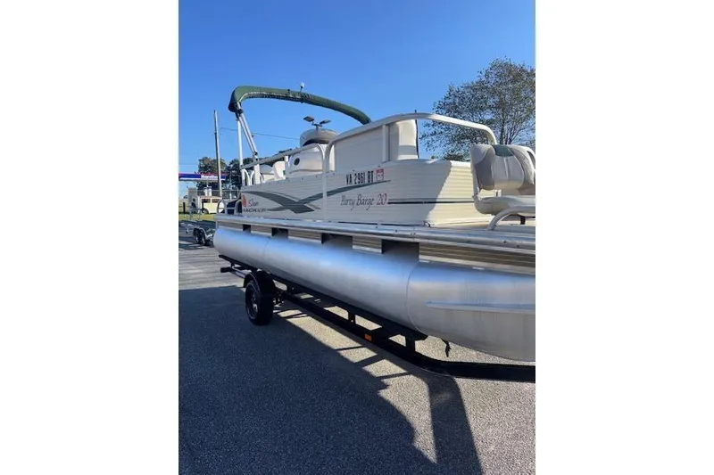 Slide: The Image of 2010 Sun Tracker Party Barge 20 Classic pontoon boat on trailer, sunny day. - 3