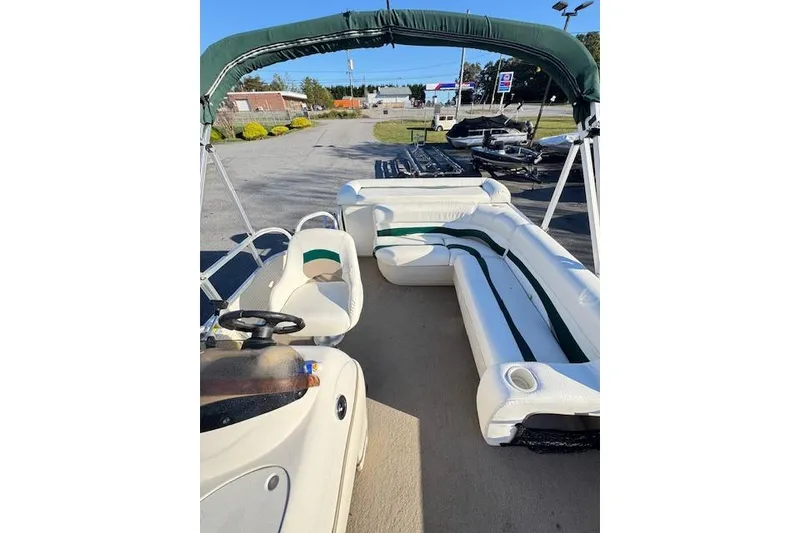 Slide: The Image of 2010 Sun Tracker Party Barge 20 Classic Series with green canopy and white seating. - 8