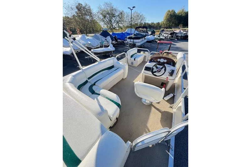 Slide: The Image of 2010 Sun Tracker Party Barge 20 Classic Series pontoon boat interior with seating and steering console. - 9