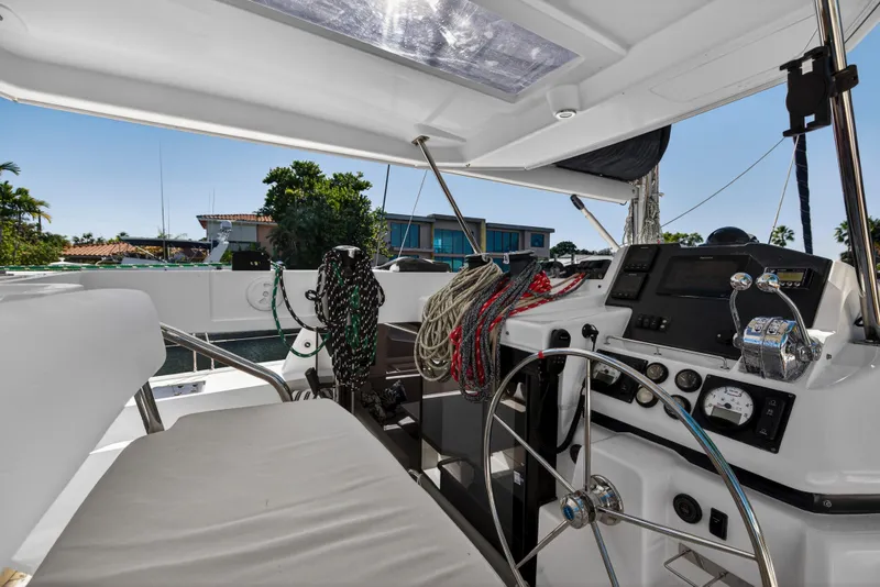 Slide: The Image of Helm of 2019 Leopard 45 catamaran with steering wheel and navigation controls. - 10