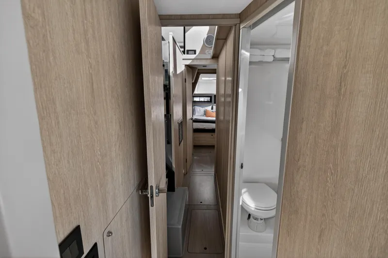 Slide: The Image of Interior of 2019 Leopard 45 yacht showing hallway, bathroom, and bedroom. - 108