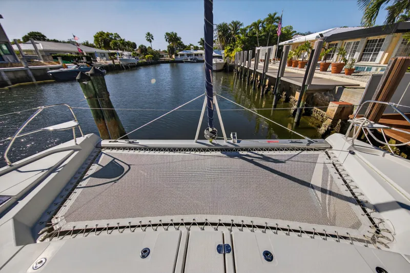 Slide: The Image of 2019 Leopard 45 catamaran docked in a sunny, tropical canal setting. - 12