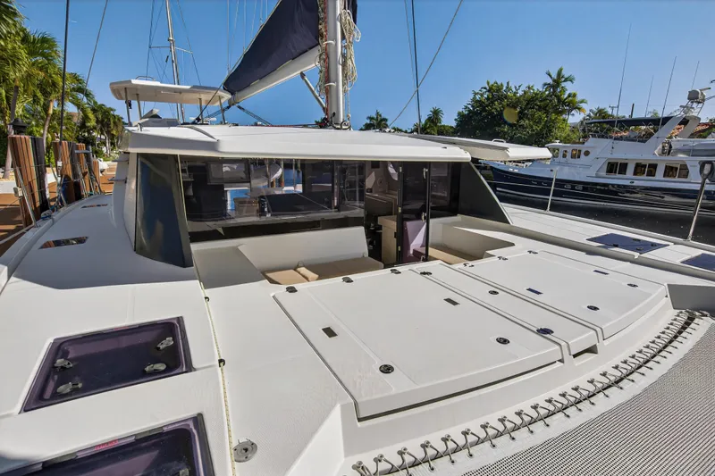 Slide: The Image of 2019 Leopard 45 catamaran docked, showcasing spacious deck and modern design. - 13