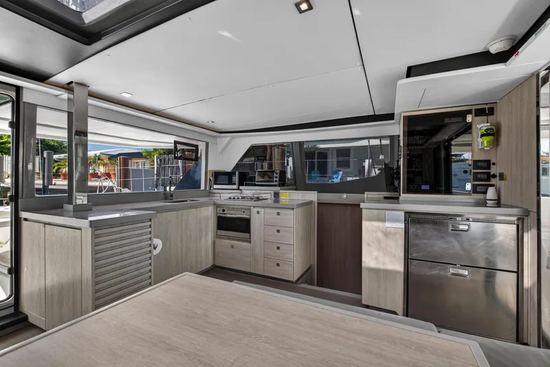 Slide: The Image of Modern kitchen interior on a 2019 Leopard 45 yacht, featuring sleek cabinetry and appliances. - 18