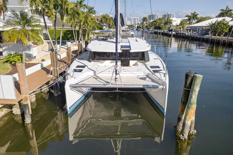 Slide: The Image of 2019 Leopard 45 catamaran docked in a scenic marina with palm trees. - 25