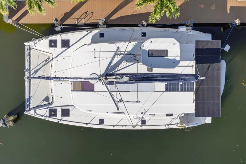Slide: The Image of Aerial view of 2019 Leopard 45 catamaran docked, showcasing solar panels and sleek design. - 26