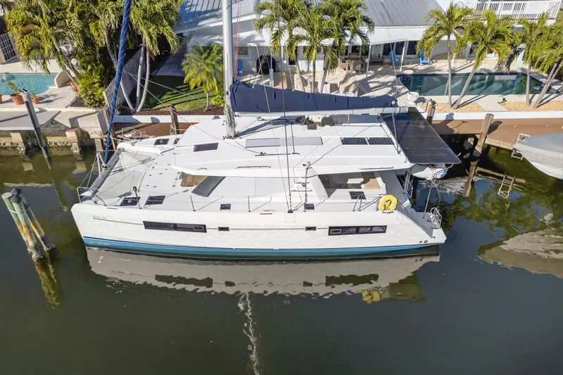 Slide: The Image of 2019 Leopard 45 catamaran docked by a tropical waterfront home. - 30
