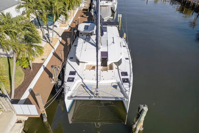 Slide: The Image of Aerial view of 2019 Leopard 45 catamaran docked by palm trees. - 32