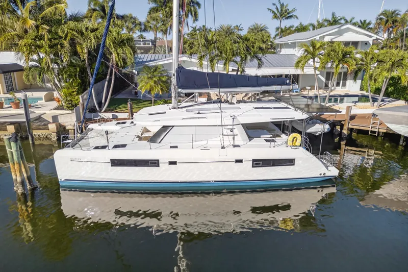 Slide: The Image of 2019 Leopard 45 catamaran docked in a tropical marina setting. - 33