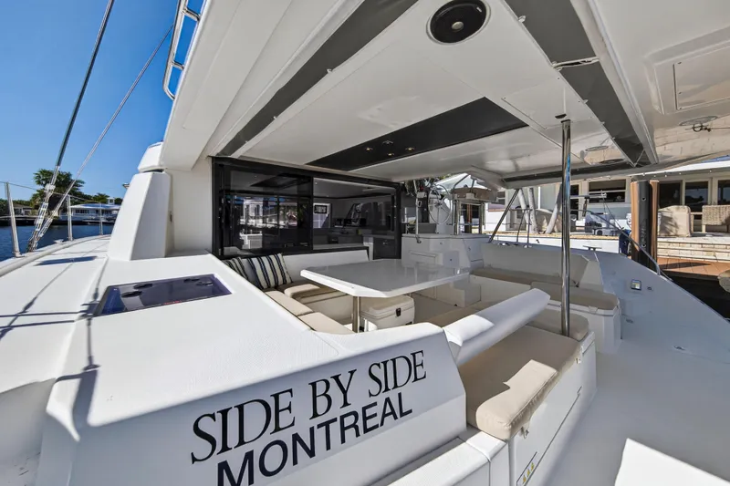 Slide: The Image of Luxurious 2019 Leopard 45 catamaran with spacious outdoor seating area, docked in a marina. - 34