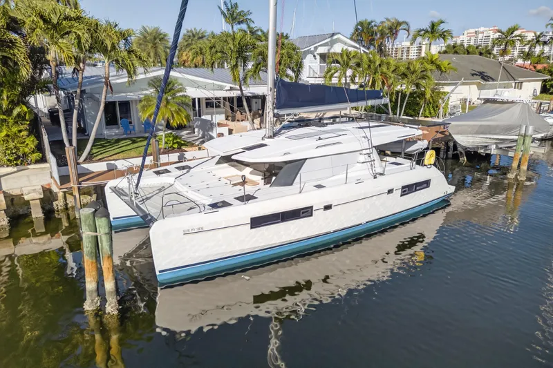 Slide: The Image of 2019 Leopard 45 catamaran docked by a tropical waterfront home. - 35