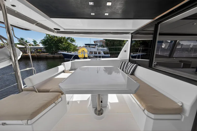 Slide: The Image of Spacious outdoor seating area on a 2019 Leopard 45 yacht, featuring a sleek table and cushions. - 37