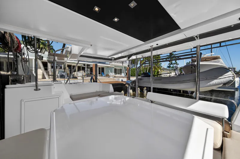 Slide: The Image of 2019 Leopard 45 yacht interior with modern seating and docked boat view. - 38