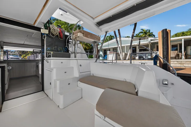 Slide: The Image of 2019 Leopard 45 yacht interior with seating, steps, and dockside view. - 39