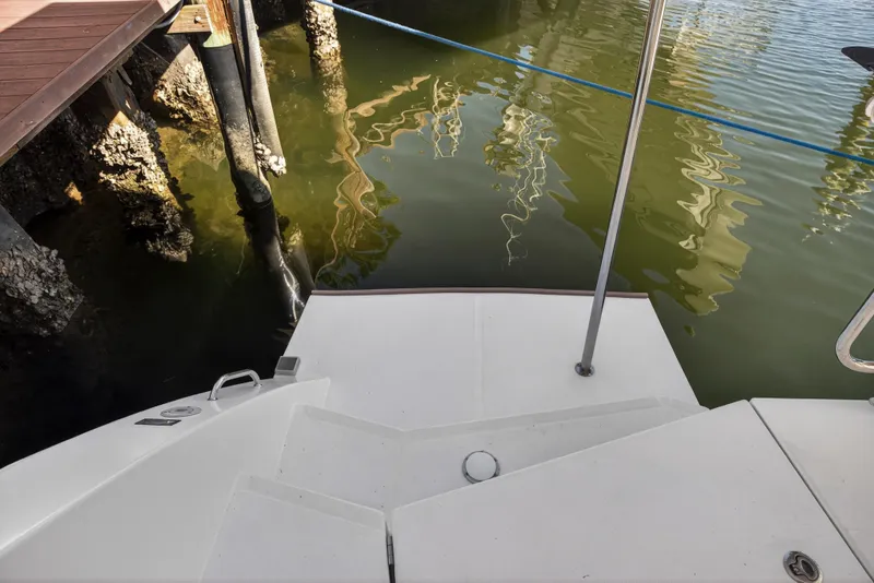 Slide: The Image of Stern view of 2019 Leopard 45 yacht docked by barnacle-covered pilings. - 41