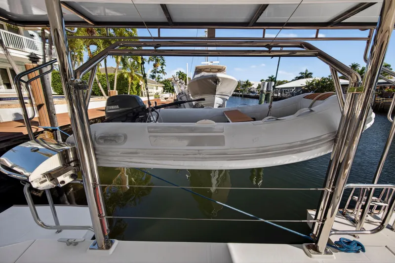 Slide: The Image of 2019 Leopard 45 yacht with dinghy and Yamaha motor in a marina setting. - 47