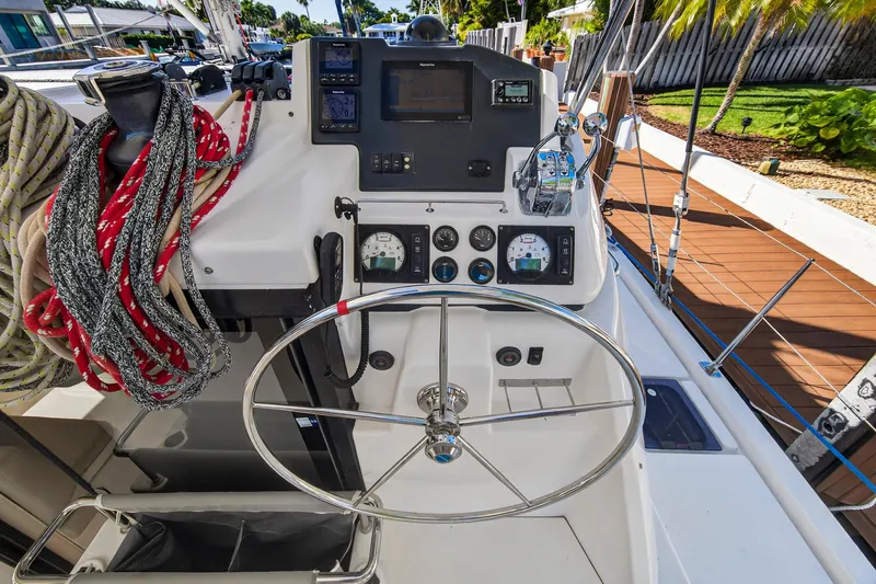 Slide: The Image of 2019 Leopard 45 yacht helm with steering wheel, navigation instruments, and colorful ropes. - 49