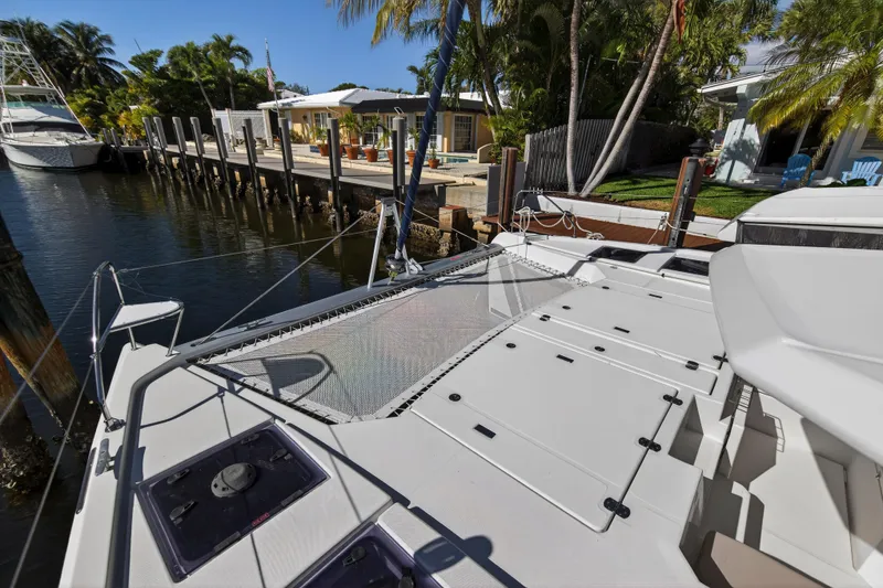 Slide: The Image of 2019 Leopard 45 catamaran docked by a tropical waterfront home. - 53