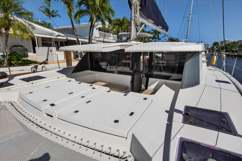 Slide: The Image of 2019 Leopard 45 catamaran docked, featuring spacious deck and modern design. - 54