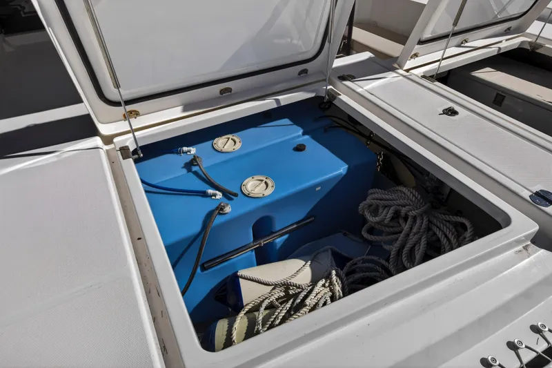 Slide: The Image of Open storage compartment on 2019 Leopard 45 yacht with ropes and blue tank. - 58