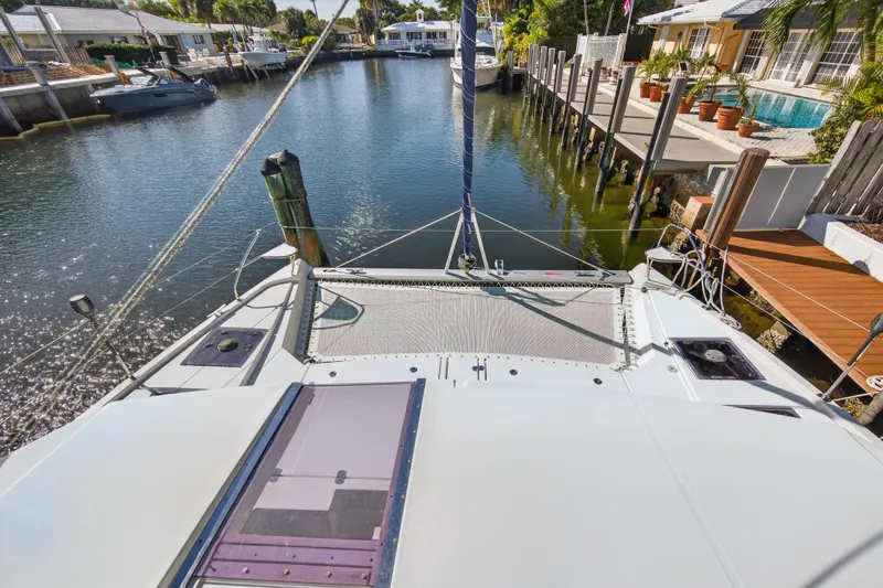 Slide: The Image of 2019 Leopard 45 catamaran docked in a sunny residential canal setting. - 67