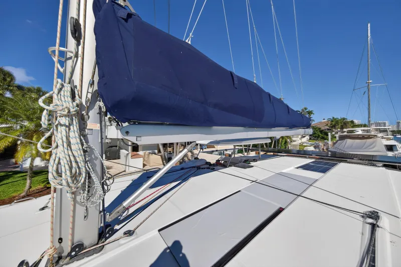 Slide: The Image of 2019 Leopard 45 sailboat deck with blue sail cover and rigging. - 68
