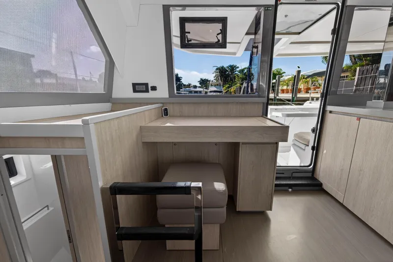 Slide: The Image of Interior of a 2019 Leopard 45 catamaran with modern wood finish and outdoor view. - 78