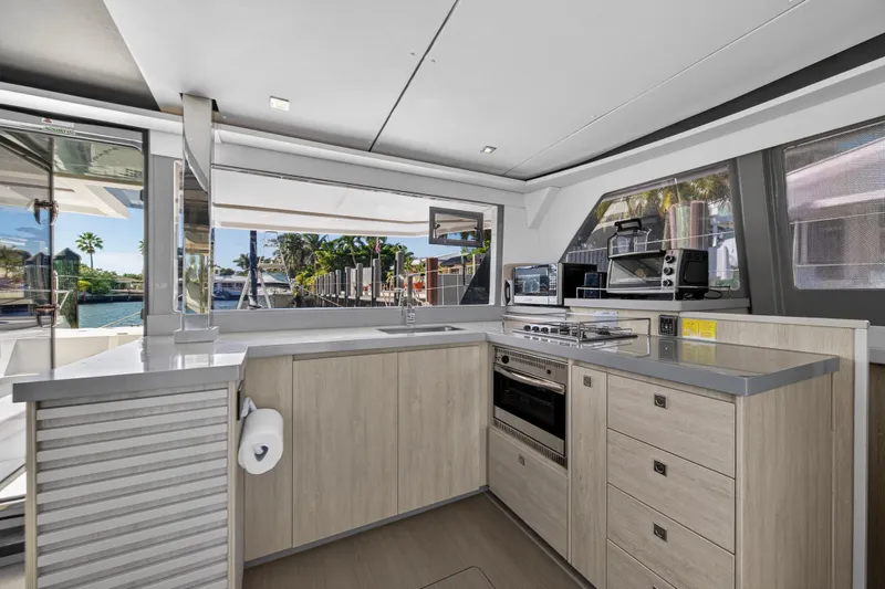 Slide: The Image of Modern kitchen interior on a 2019 Leopard 45 yacht, featuring sleek cabinetry and appliances. - 79