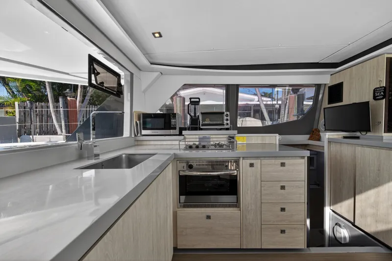 Slide: The Image of Modern kitchen interior on a 2019 Leopard 45 yacht, featuring sleek countertops and appliances. - 80