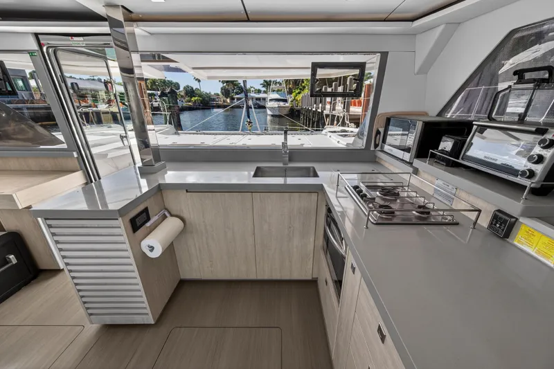 Slide: The Image of Modern kitchen interior on a 2019 Leopard 45 catamaran, featuring sleek countertops and appliances. - 81